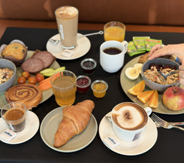 Breakfast table with coffee, bread and cold cuts
