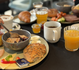 Plate with breakfast and juice on a café table