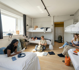 Guests spending time in a common room at Danhostel Copenhagen City